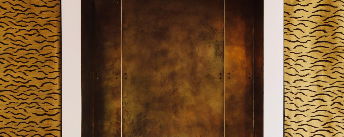 Patinated bronze panel with white framing and tiger-stripe upholstery detail