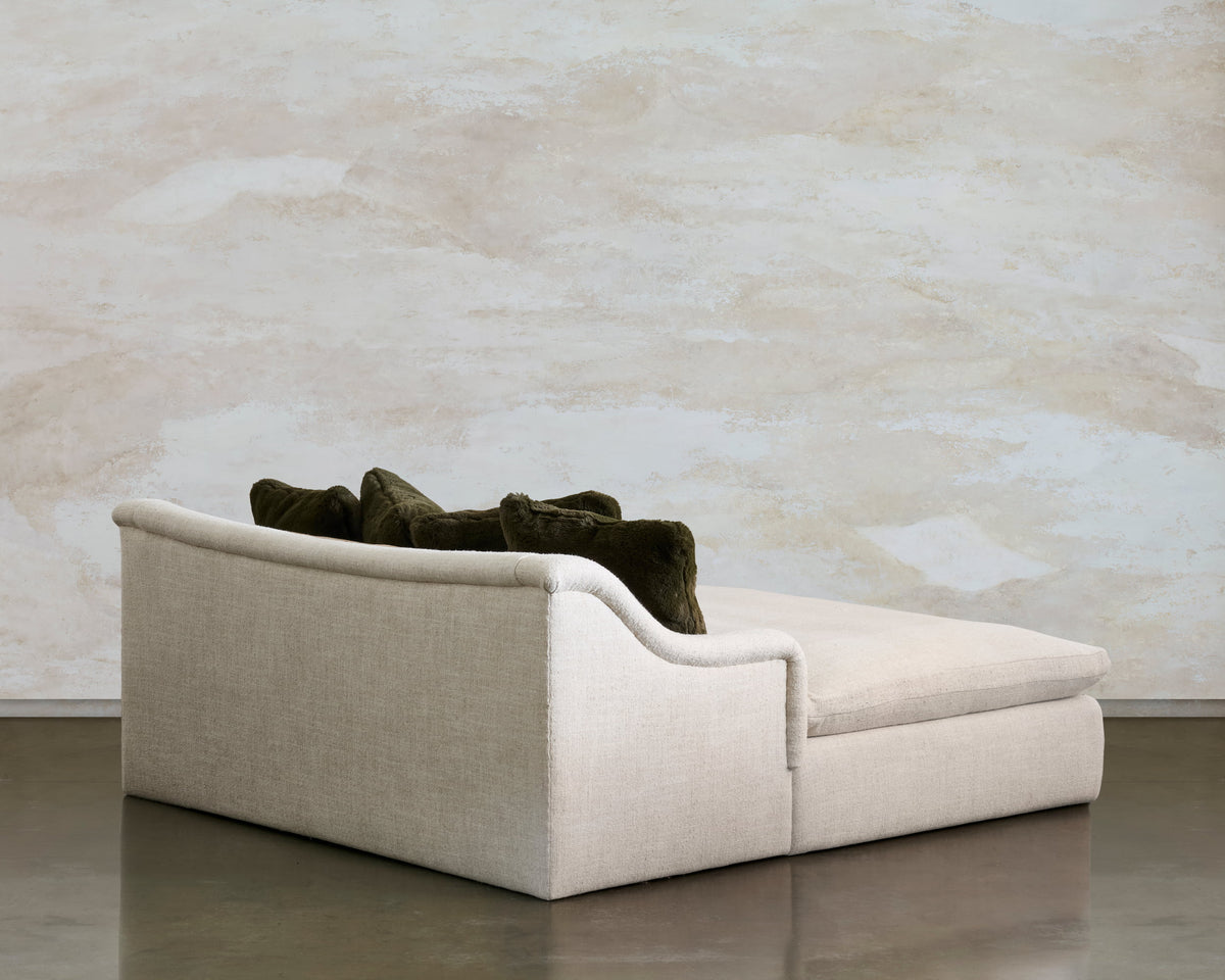 Three-quarter view of the Lazy Sunday lounge, with a curved cream arm and olive back cushions