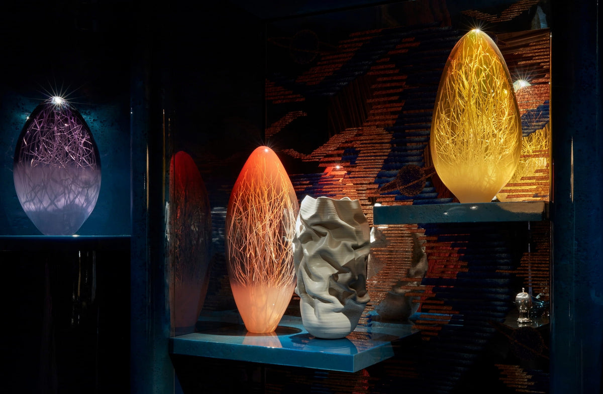 Illuminated glass vessels on teal shelves in the Home Bar at WOW!house 2023 by Tala Fustok Studio