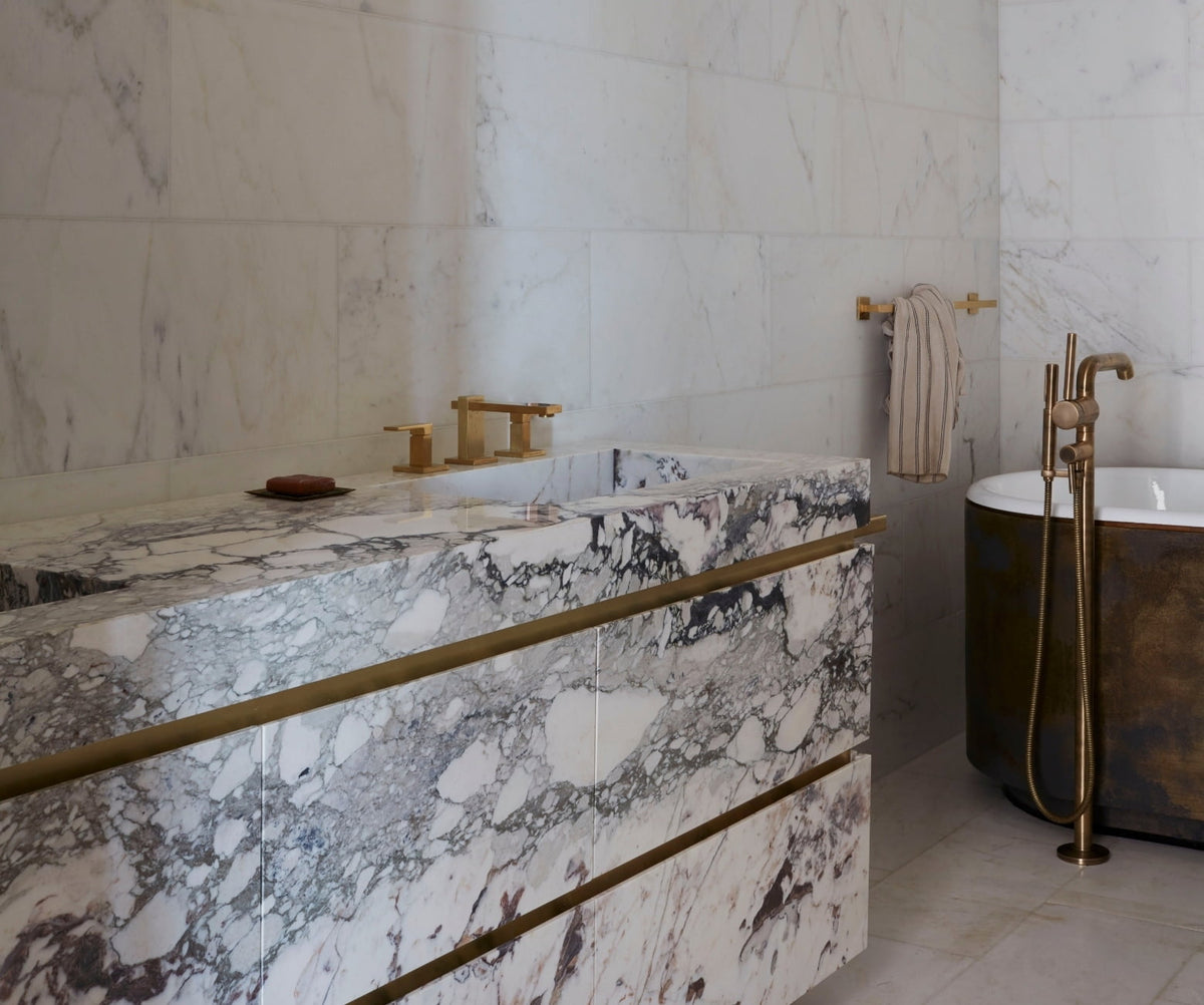Bathroom with a viola marble vanity and patinated bronze bathtub in the New York SoHo apartment