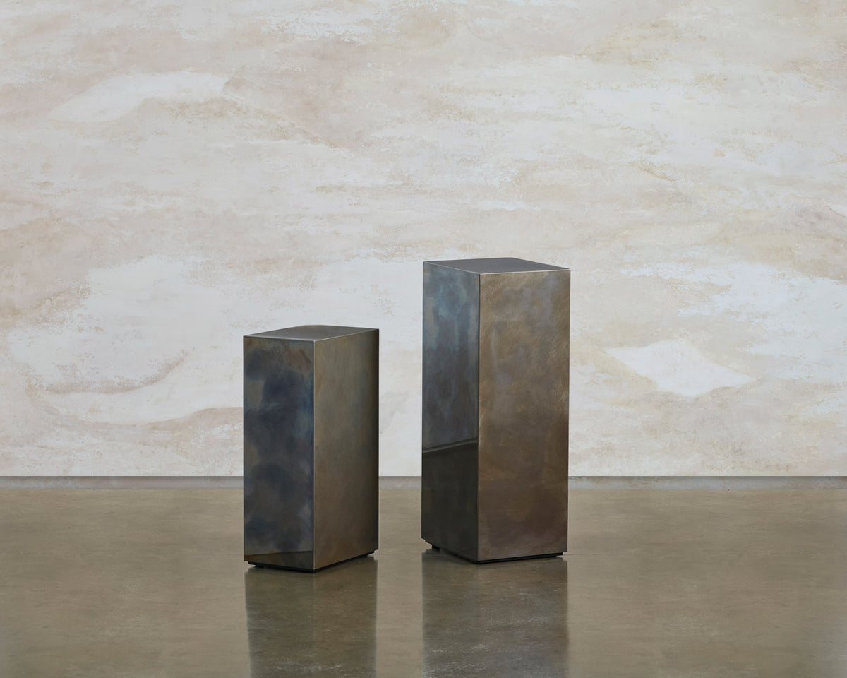 Two Tandem blocks standing apart, a shorter column beside a taller patinated steel block