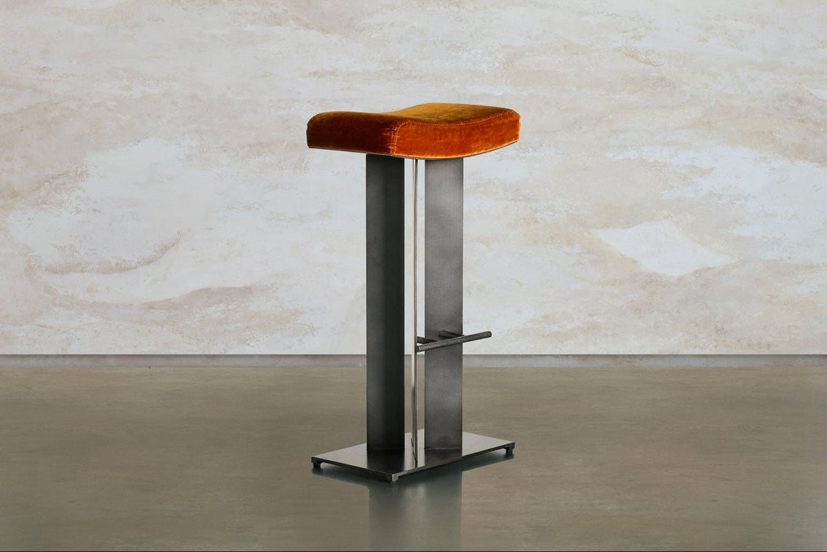 Tonic barstool by Tala Fustok Studio, with an orange velvet seat on a dark steel frame